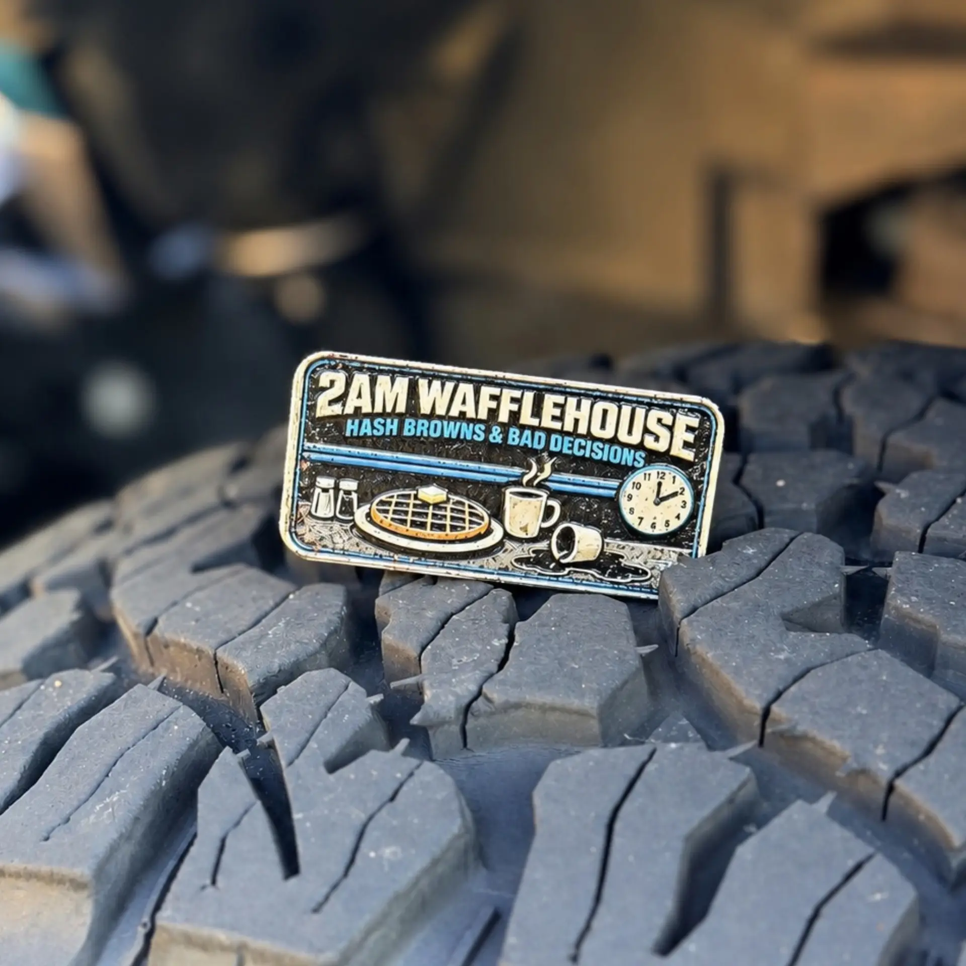 2am Wafflehouse trail badge photographed on a tire