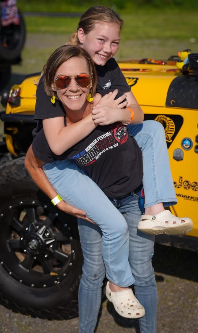 Melinda with her daughter at a Jeep festival