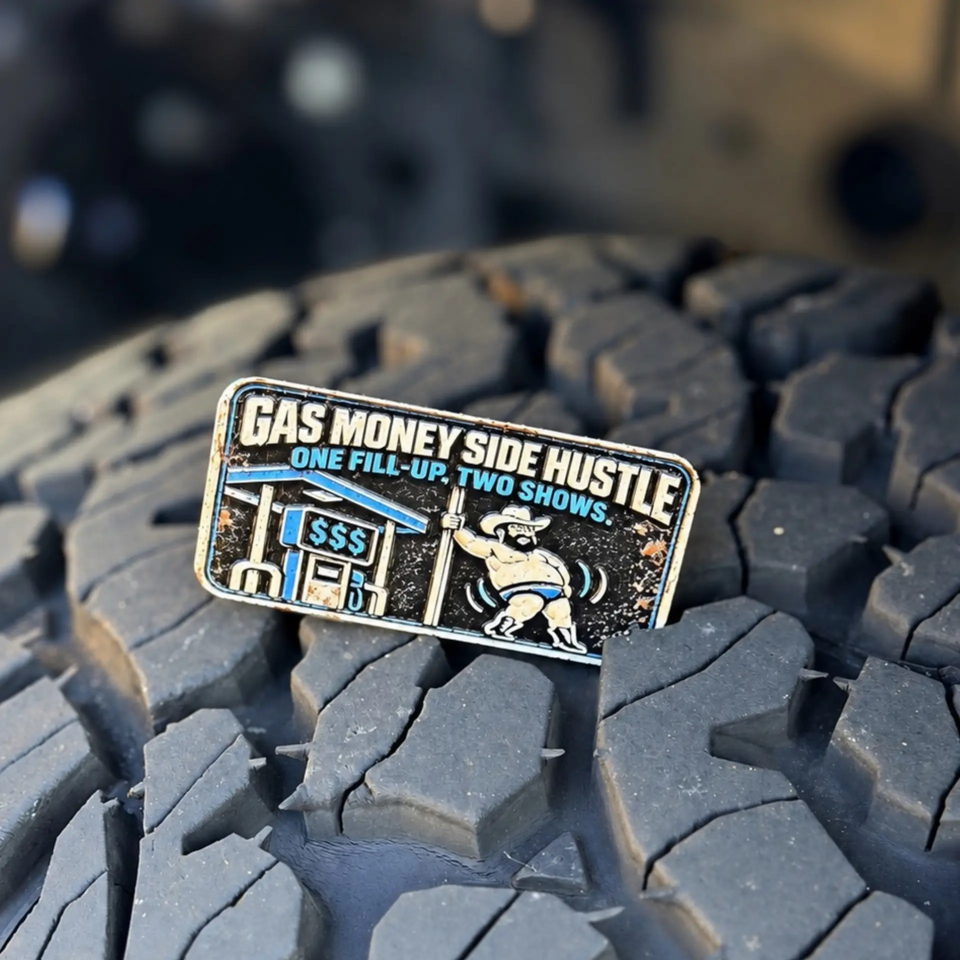 Gas Money Side Hustle trail badge photographed on a tire